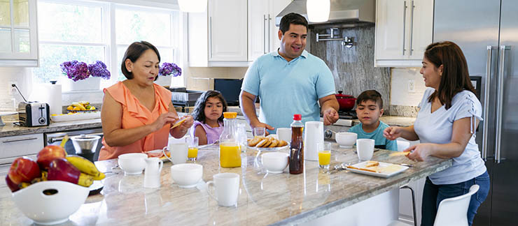 Multigenerational family having breakfast together in the kitchen.