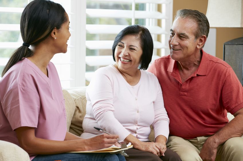 Caregiver interviewing elderly couple