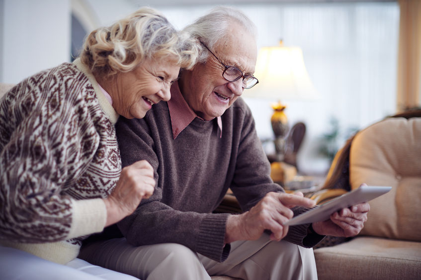 Elderly couple with tech gadget