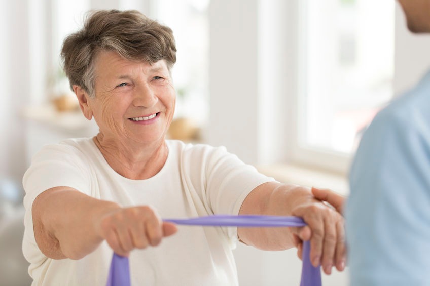 Elderly woman exercising with exercise band
