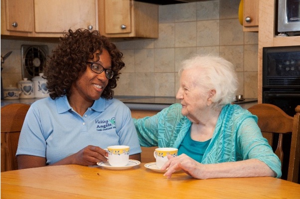 Caregiver spending time with elderly woman