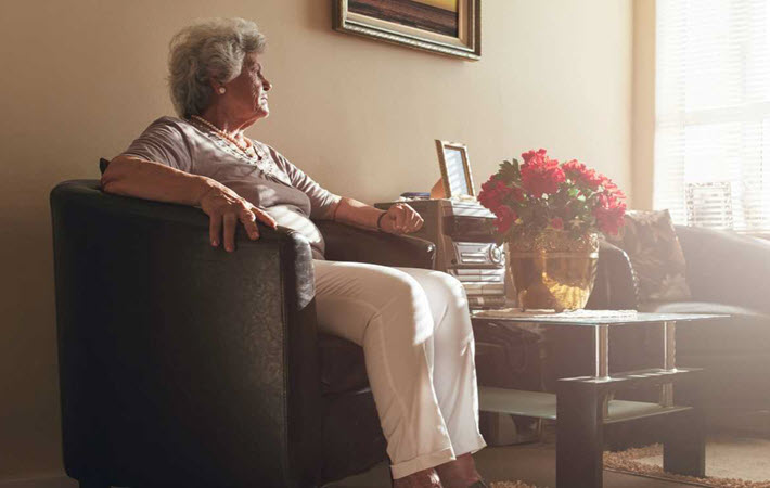 Elderly woman looking out the window