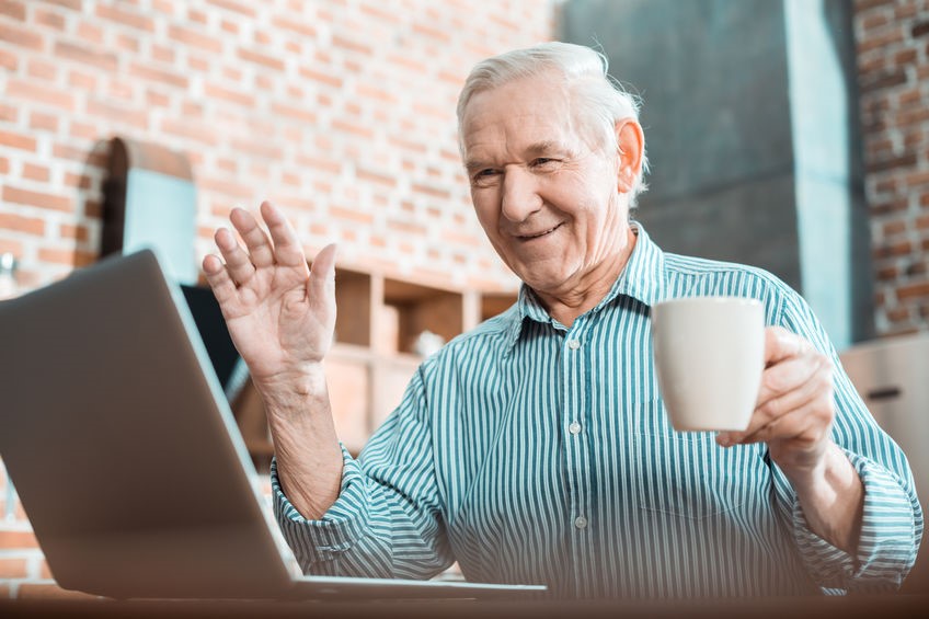 Senior man having a video call on the laptop