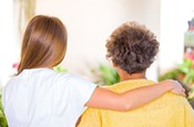 Caregiver assisting senior woman