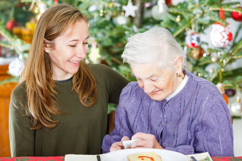 Adult daughter celebrating the holidays with senior mother