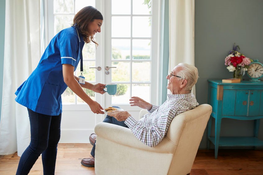 Caregiver assisting elderly man