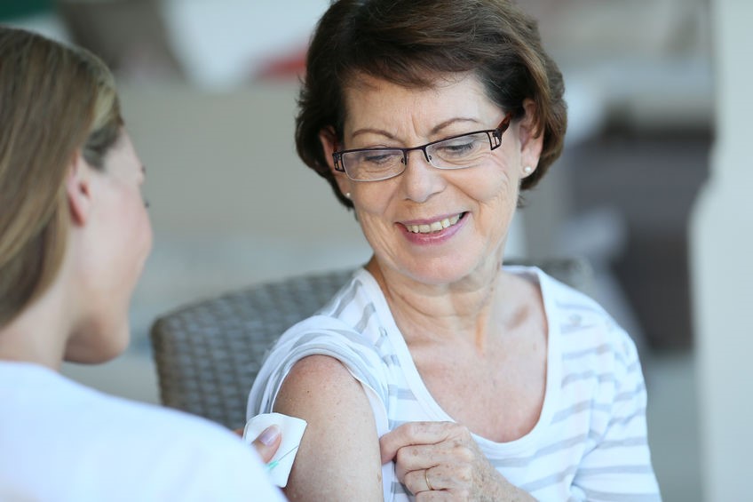 Senior woman getting a flu vaccine