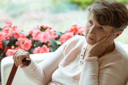 Elderly woman sitting alone