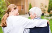 Caregiver assisting senior woman