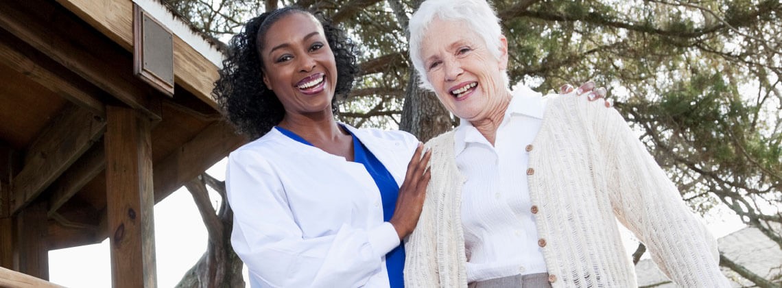 Caregiver smiling with senior woman