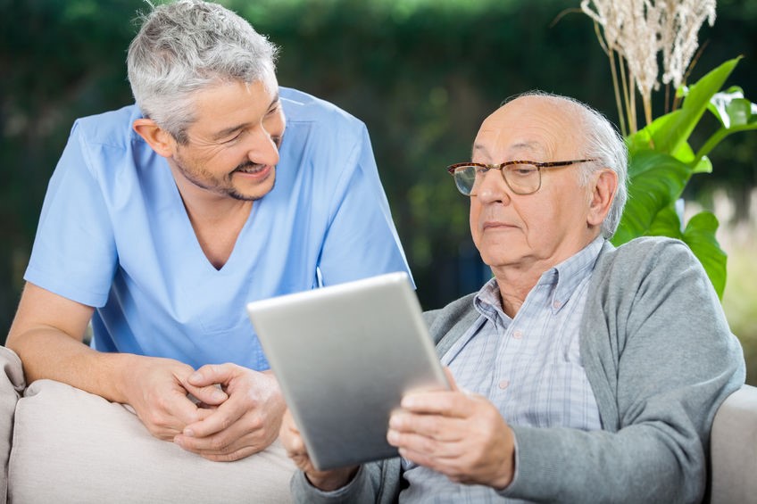 Caregiver assisting elderly man