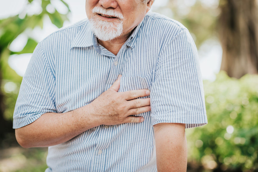 Elderly man holding his chest