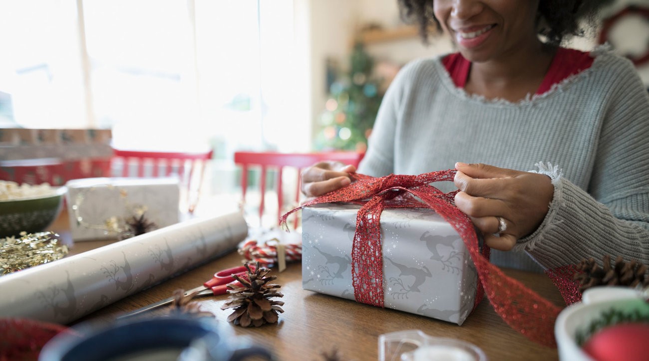 Companion care - Home care aide wrapping a holiday gift