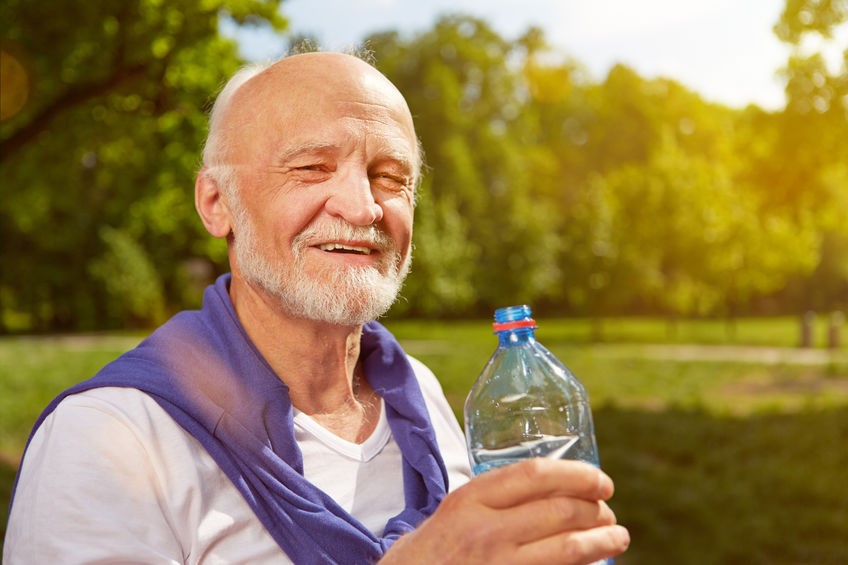 Elderly man drinking water