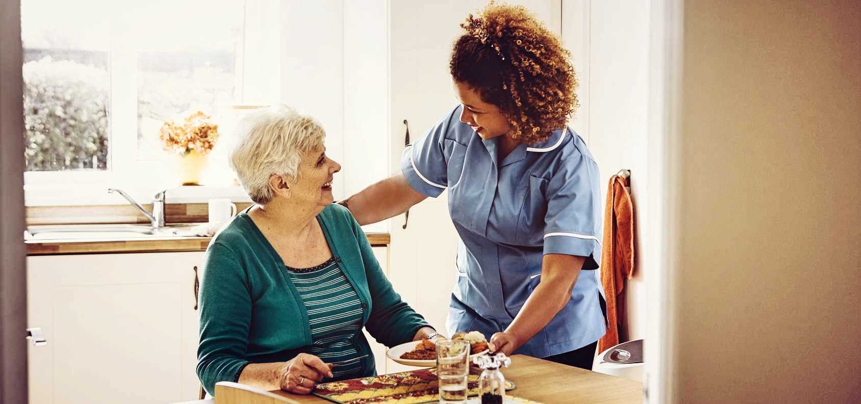 In-home caregiver provides assistance to senior living at home