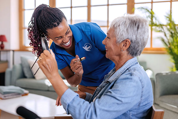 provider of home care in Perry assisting elderly patient on to couch