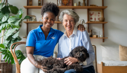 A Visiting Angels caregiver sitting next to an elderly woman.