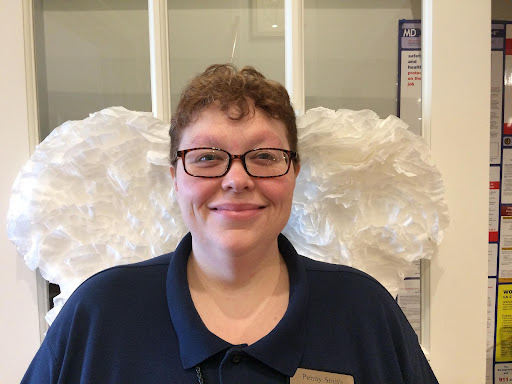 Penny in front of white angel wings