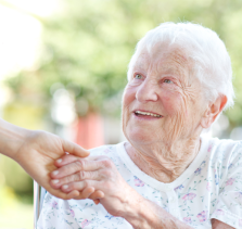 provider of elder care in Kirkland holding senior patient’s hand