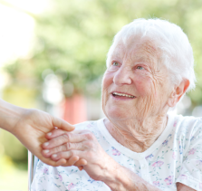 provider of elder home care in Portland shaking hands with elderly woman