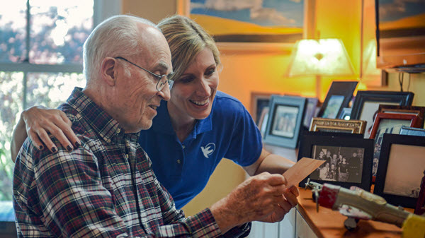 in home care aide providing companionship to elderly with dementia 