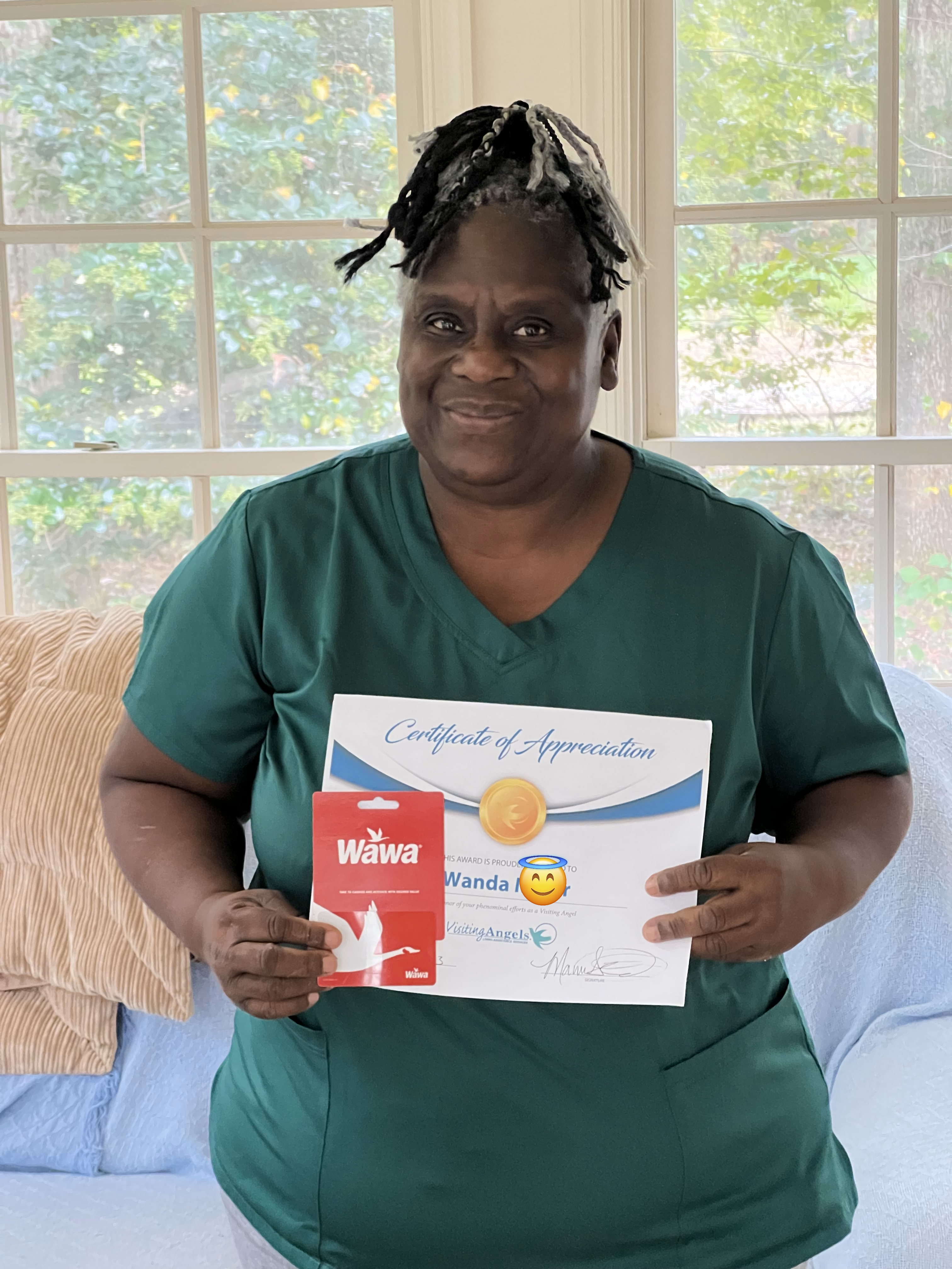 Caregiver holding certificate and gift card