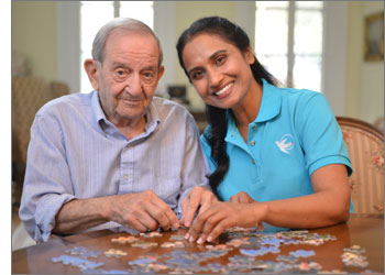 Caregiver and client doing a puzzle